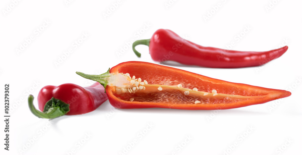 Cut red peppers on a white background