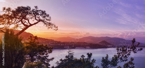 Panoramic view over a coastal town at sunset photo