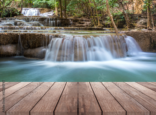waterfall in deep forest of thailand and wood plank