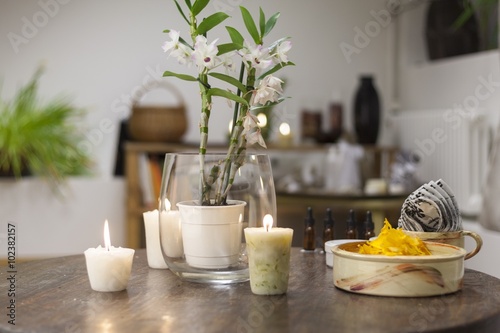 Flowers, candles and healthy snacks on the beauty salon table