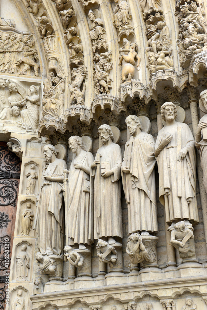 Close up of artwork and carvings in the Notre Dame Cathedral, situated along the Seine River in Paris, France
