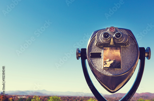 Coin-operated viewer looking out over an autumn landscape