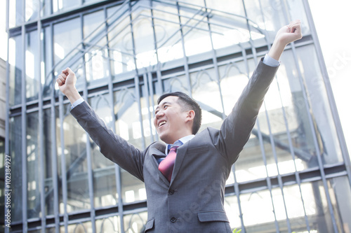 Young Business Person with raised arms screaming