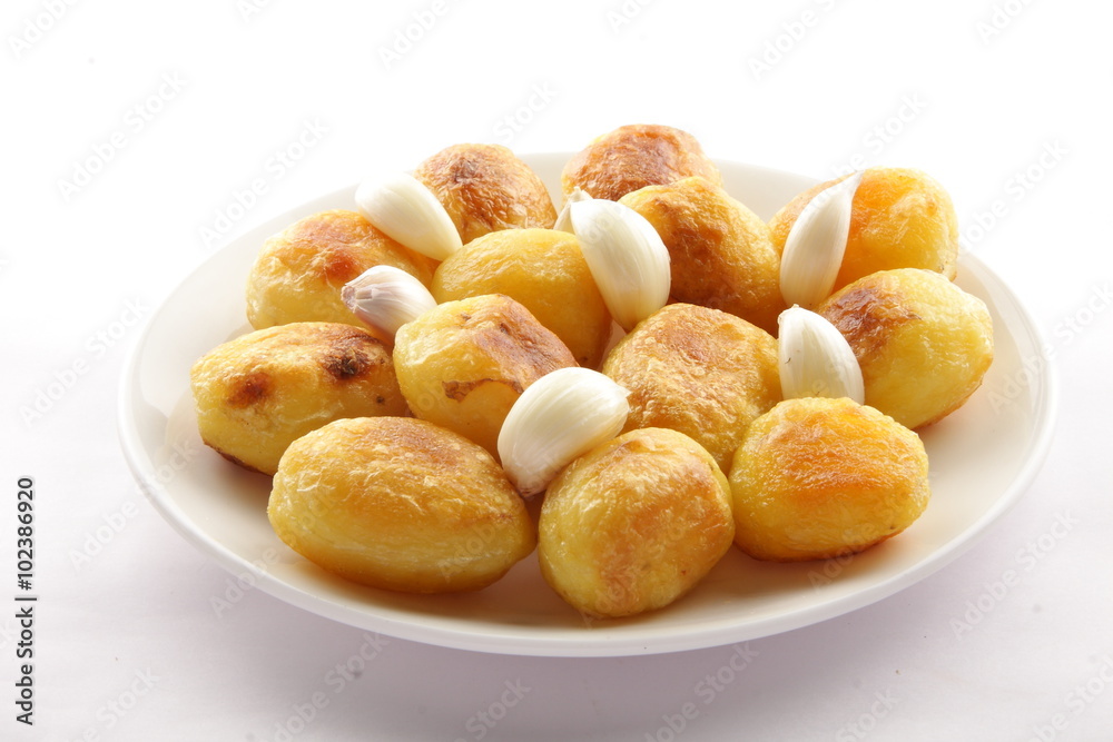 Crispy baked potatoes with garlic,Selective focus . Crispy baked potatoes with garlic,Selective focus .