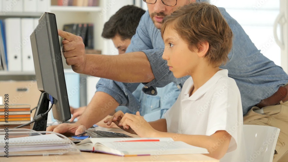 Teacher with kids in computing class Teacher with kids in computing class