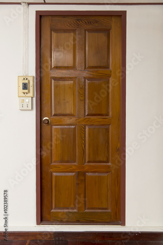 Old grunge brown wood door with wood frame and wall