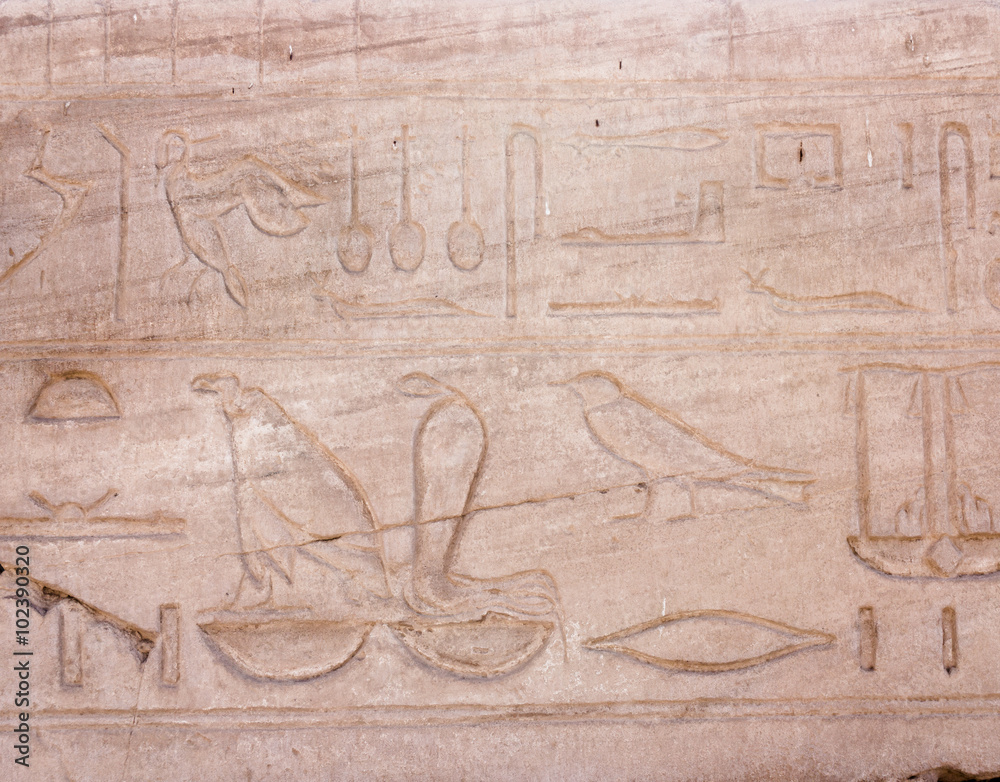 Egyptian hieroglyphs. Hieroglyphic carvings on a wall Egyptian hieroglyphs. Hieroglyphic carvings on a wall