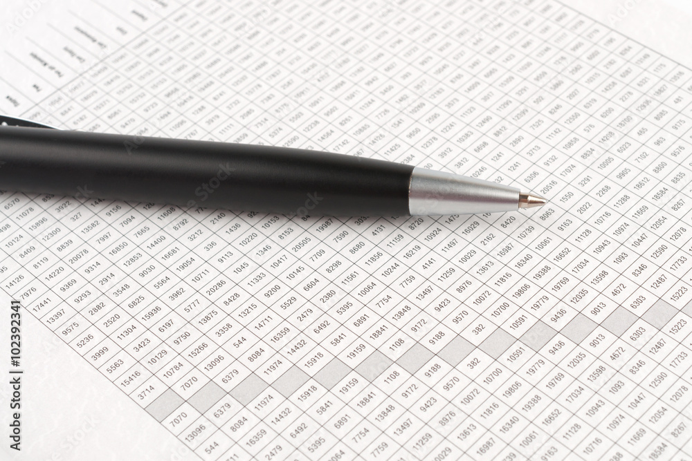 Naklejka premium Ballpoint pen on the background of a digital table