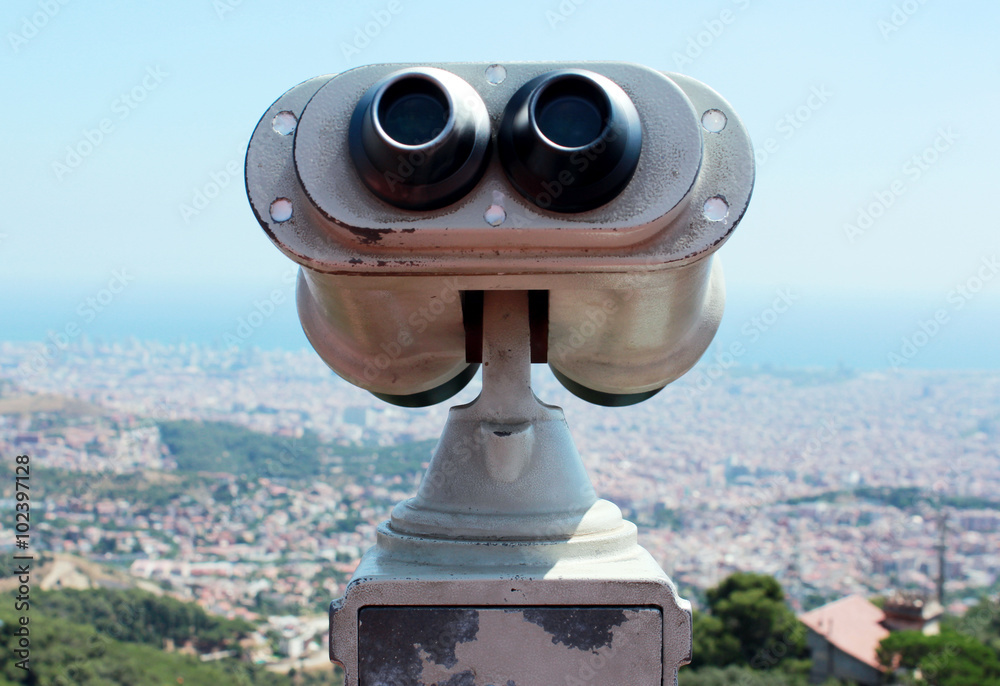 viewing platform with binoculars overlooking the city from bird's-eye view