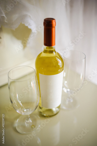 glasses with white wine bottle
