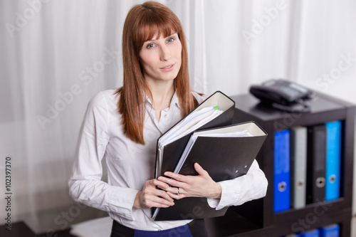 Businesswoman holding folders.