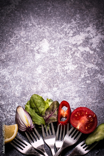 Fototapeta Naklejka Na Ścianę i Meble -  Fresh mixed vegetables on fork on black background
