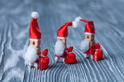 Christmas concept - clothespin. Three of Santa Claus. Retro Sant