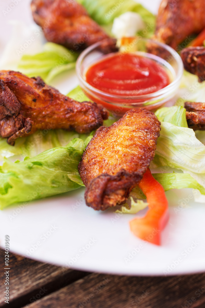 Grilled chicken wings with spicy ketchup.