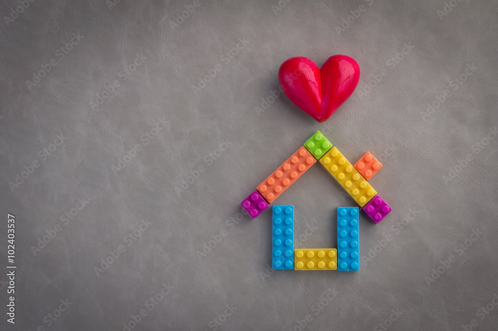 House concept with plastic blocks toy and heart object