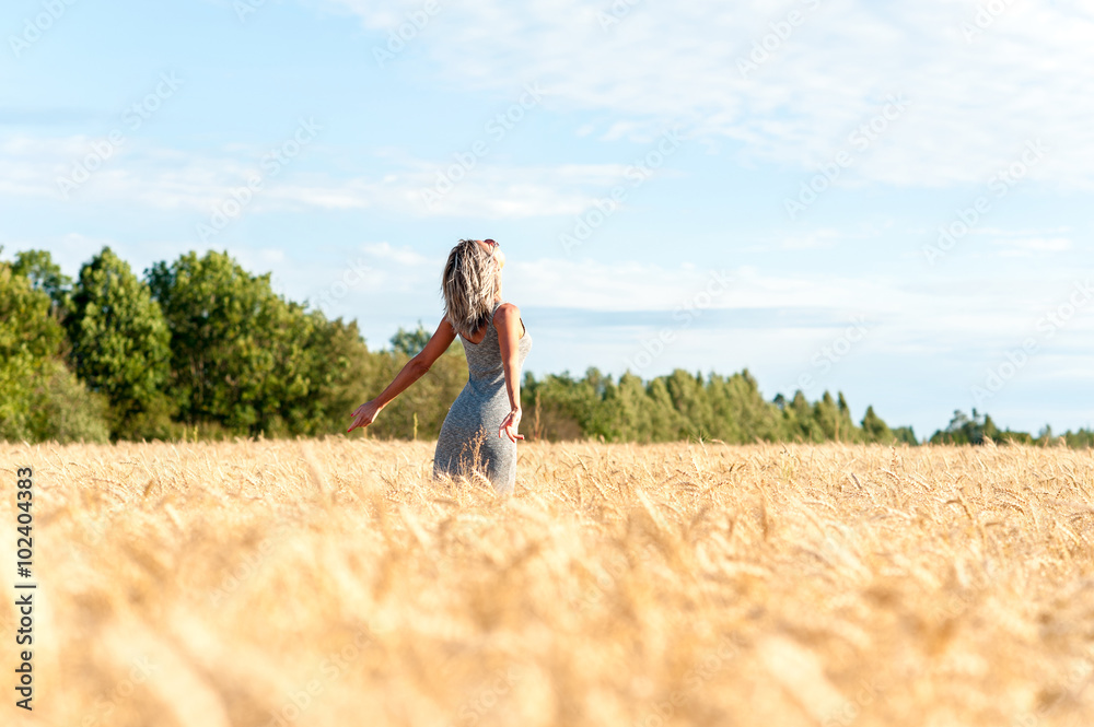 Young cheerful woman her face upward with opened outstretched ar