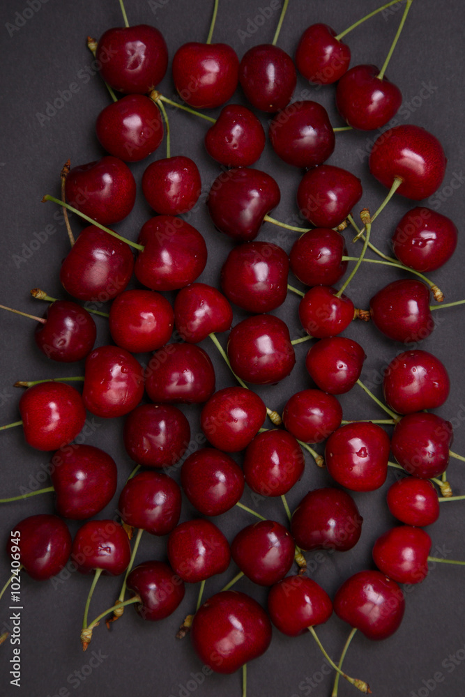 Tasty fresh cherries on black background Tasty fresh cherries on black background