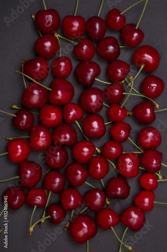 Tasty fresh cherries on black background