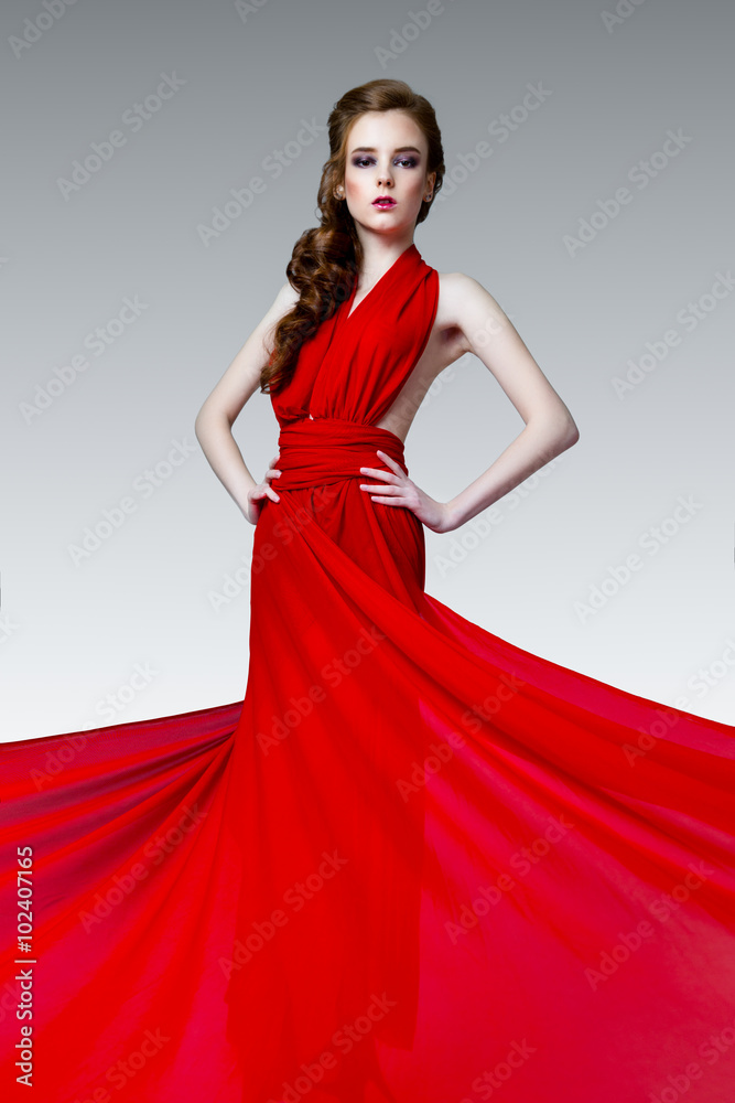 Fashion photo of young magnificent woman in red long dress, studio photo Fashion photo of young magnificent woman in red long dress, studio photo