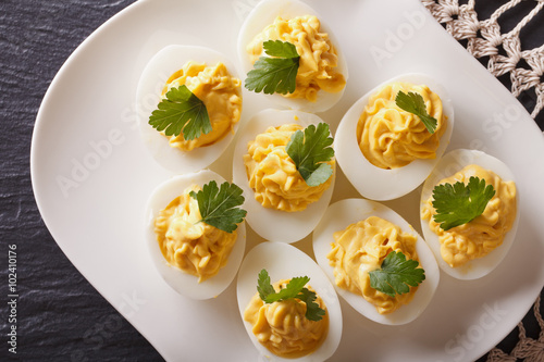 Stuffed eggs with mustard and parsley close-up. Horizontal top view
