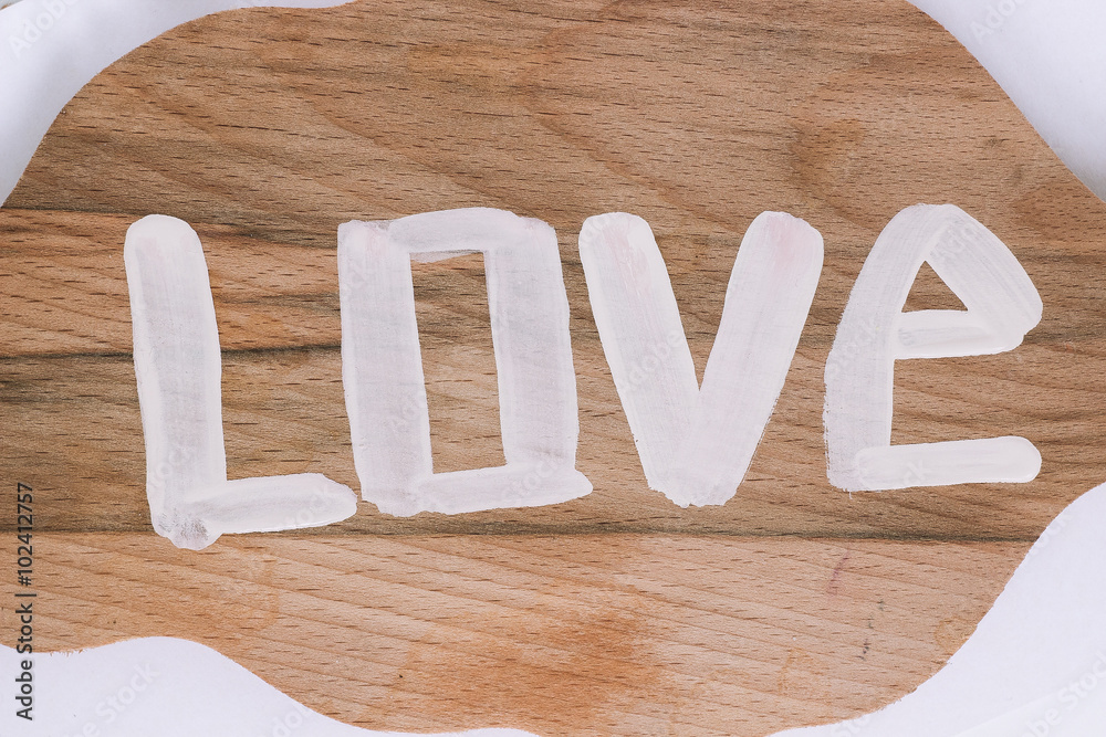 white love text sign on wooden surface closeup white love text sign on wooden surface closeup