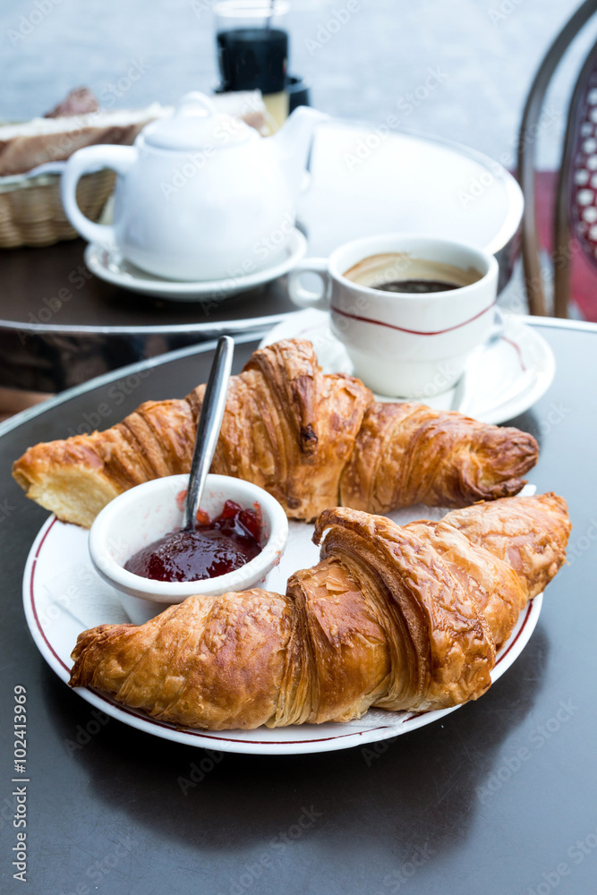 Breakfast with coffee and croissants on table Breakfast with coffee and croissants on table