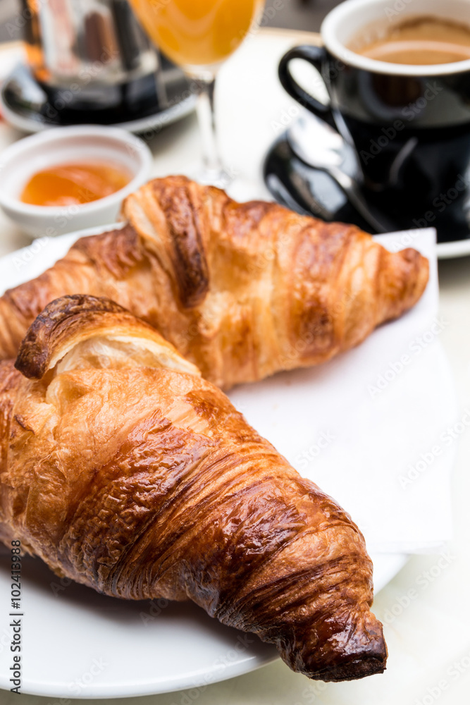 Breakfast with coffee and croissants on table Breakfast with coffee and croissants on table