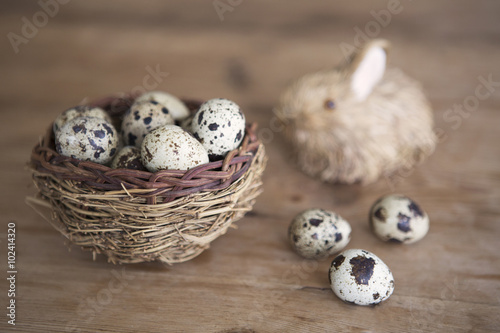 easter bunny with basket of quail eggs
