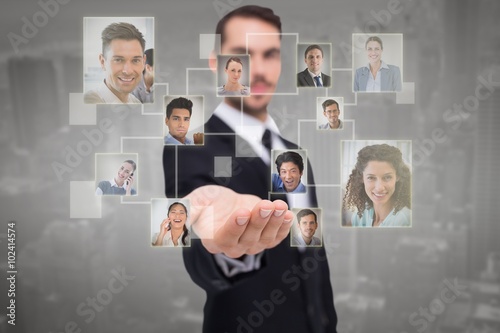 Composite image of businessman offering with his open hand