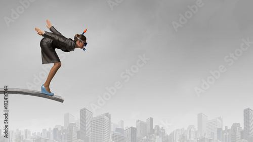 Businesswoman jumping in water