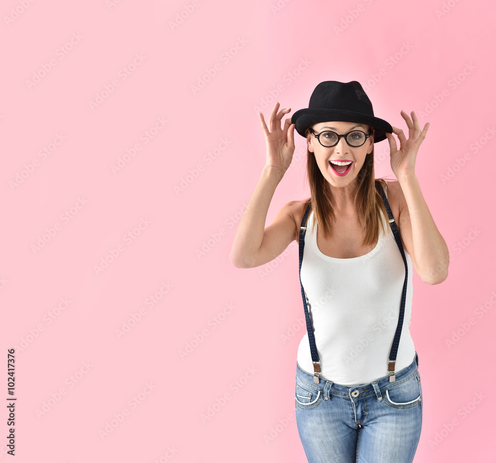 Fashion girl with hat and eyeglasses, isolated on pink background Fashion girl with hat and eyeglasses, isolated on pink background