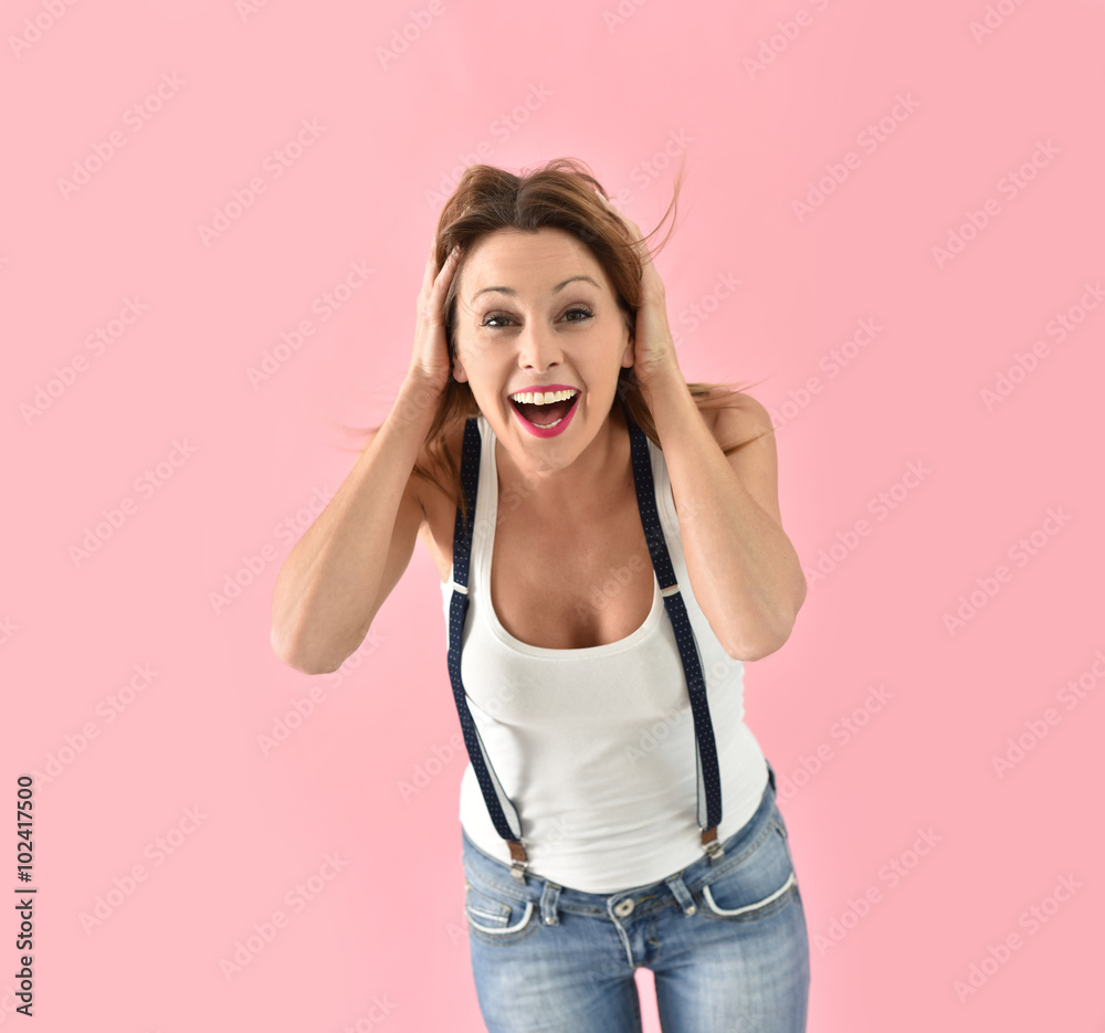 Trendy girl with suspenders moving on pink background Trendy girl with suspenders moving on pink background