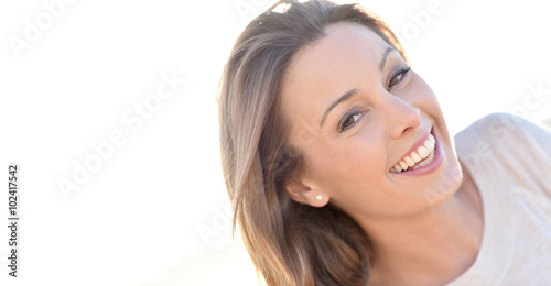Portrait of cheerful natural woman with long hair