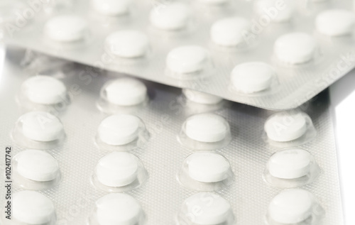 Fototapeta Naklejka Na Ścianę i Meble -  Small round pills in pack isolated on white