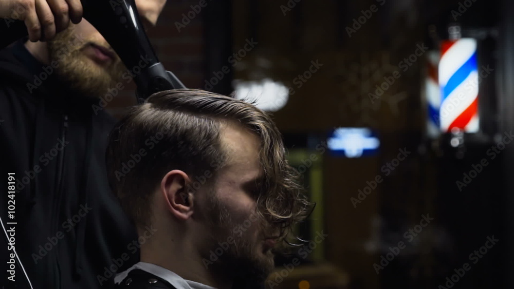 Barber drys customers hair before haircut slow motion Barber drys customers hair before haircut slow motion