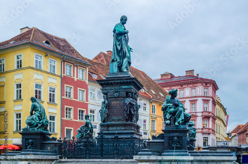 Erzherzog Johann fountain at Hauptplatz square in Graz with colorful houses behind it photo
