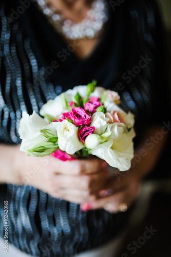 holding a bouquet of flowers