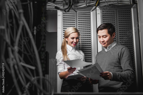 Young engineers businessmen in server room