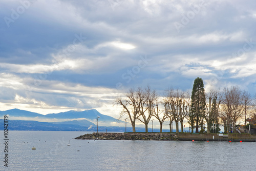Lausanne quay of Geneva Lake with trees in Switzerland