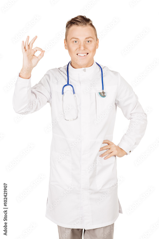 Young male doctor in white coat and stethoscope showing ok hand Young male doctor in white coat and stethoscope showing ok hand