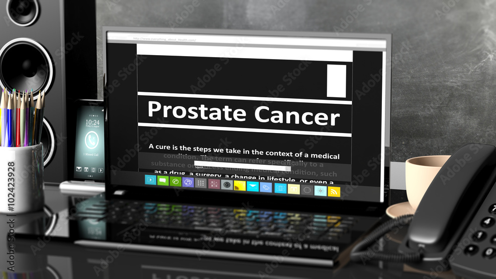Laptop with Prostate Cancer information on screen, on desktop with office objects.