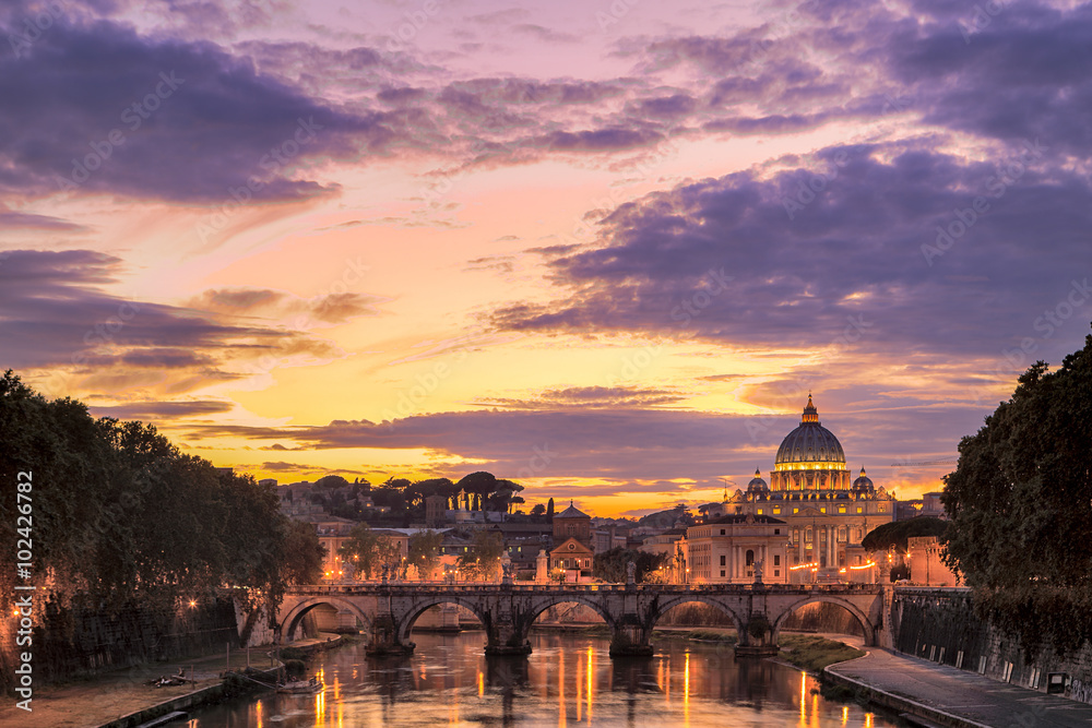Saint Peter's basilica at sunset with the Ponte Sant'Angelo in t