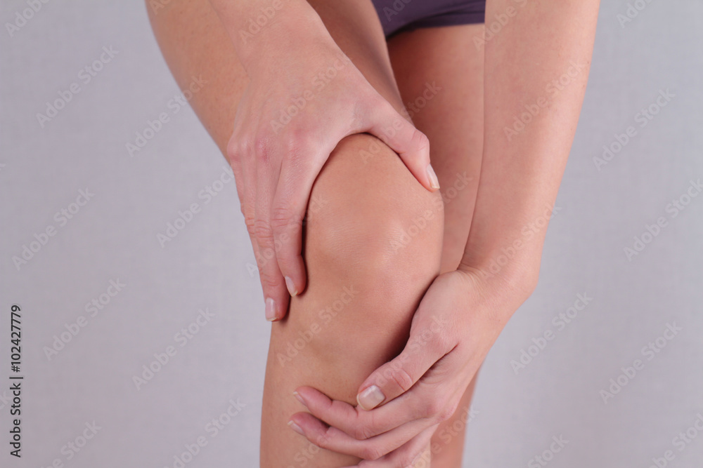 Woman with knee pain close up. Pain relief concept Woman with knee pain close up. Pain relief concept