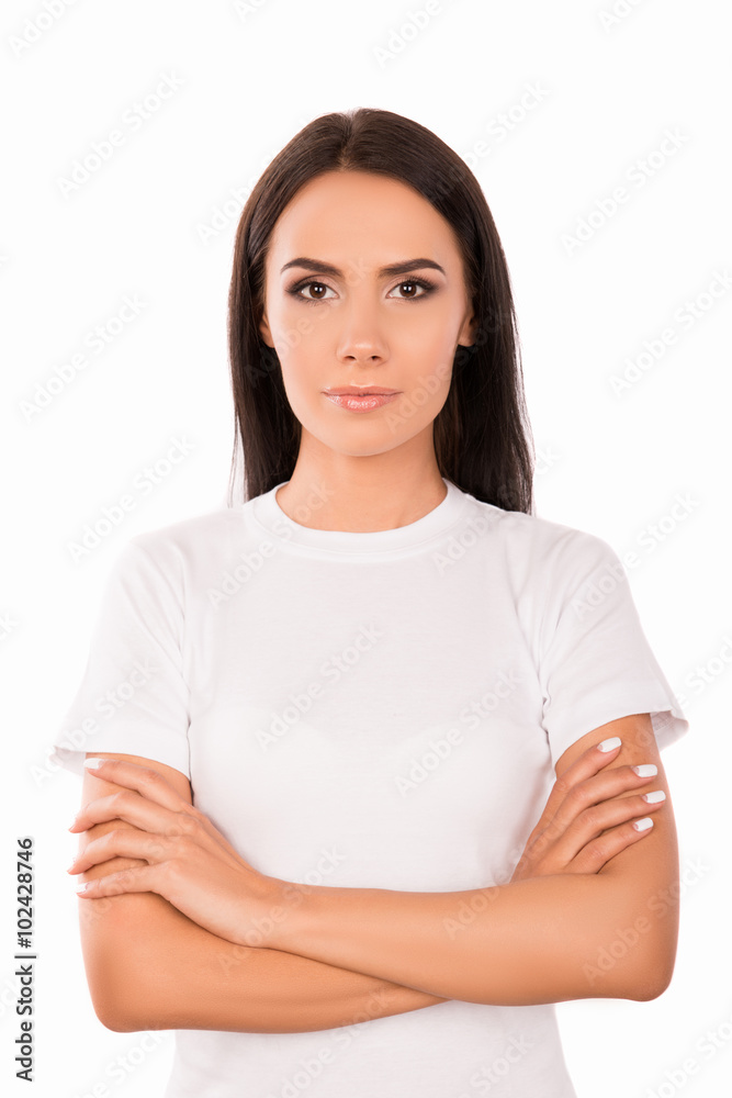 Portrait of calm minded young woman with crossed hands
