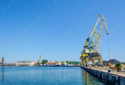 heavy cranes in bulgarian port bourgas are used for unloading cargo ships. In the vicinity is the pasenger ferry terminal. photo