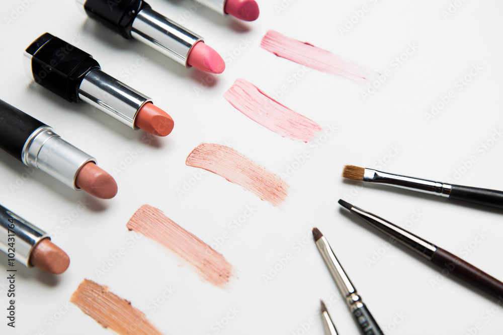 close up of lipsticks range with makeup brushes close up of lipsticks range with makeup brushes