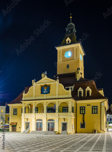 Night view of the illuminated town hall in romanian city Brasov. photo