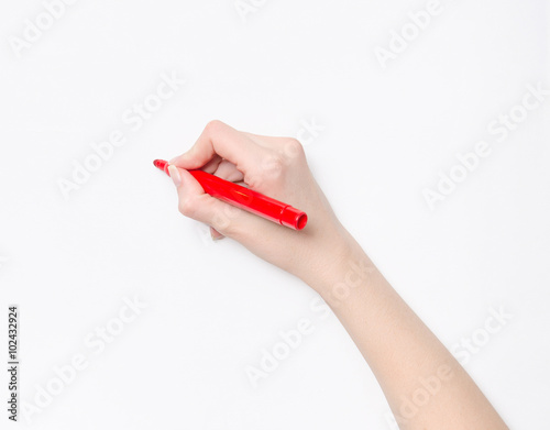 Female hand is ready for drawing with red marker