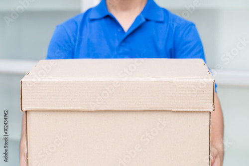 Delivery man holding a parcel box