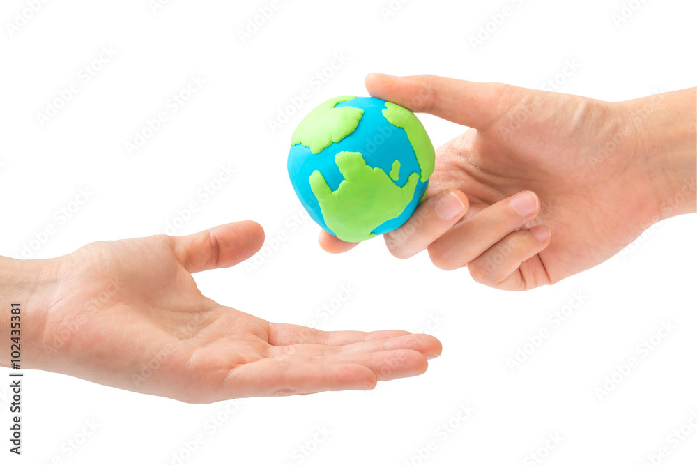 Human hand sending the earth into another hand isolated on white background. environment, Creation, Genesis, God and Adam, Responsibility, Mission concept. Human hand sending the earth into another hand isolated on white background. environment, Creation, Genesis, God and Adam, Responsibility, Mission concept.